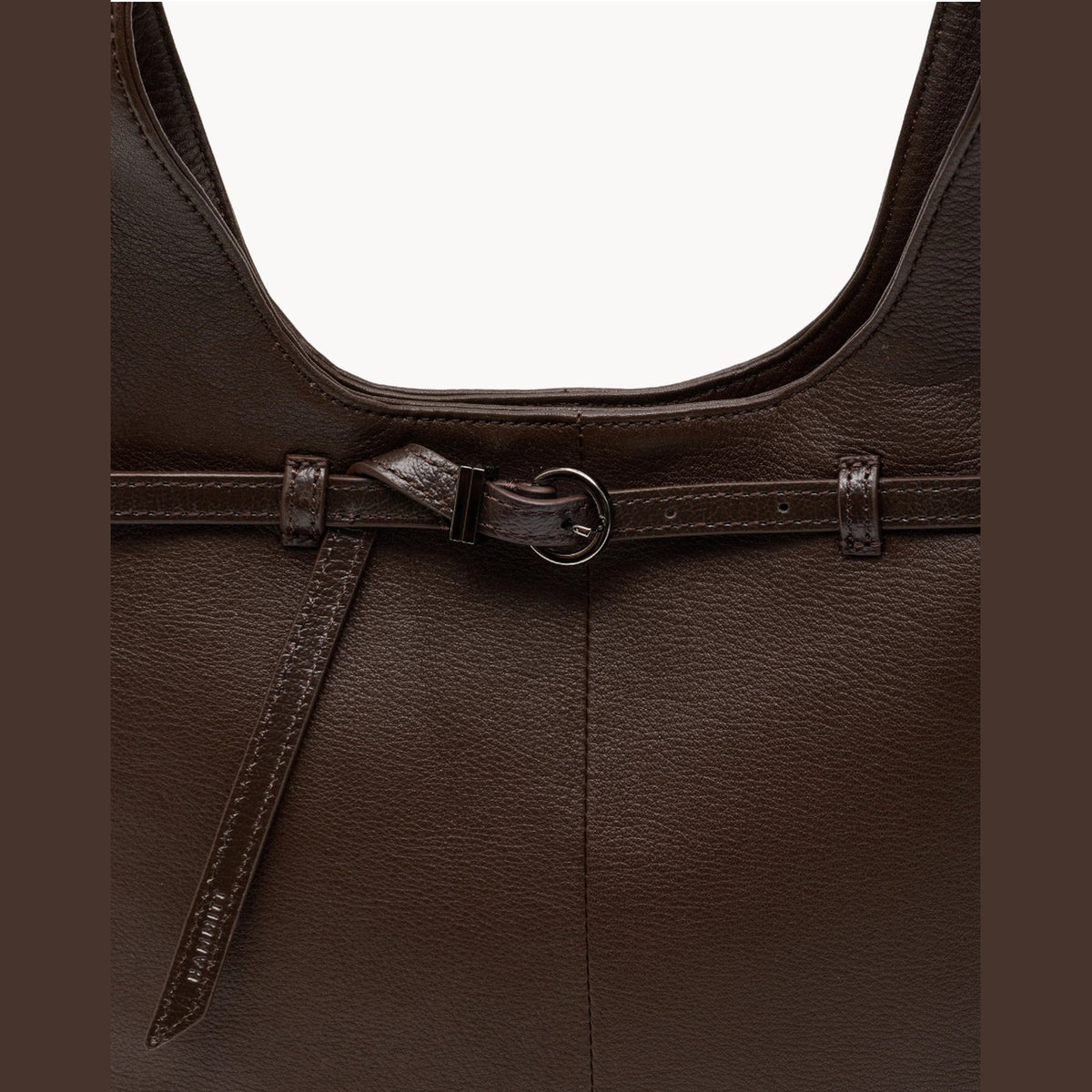 Close-up of the belted front strap with gunmetal buckle